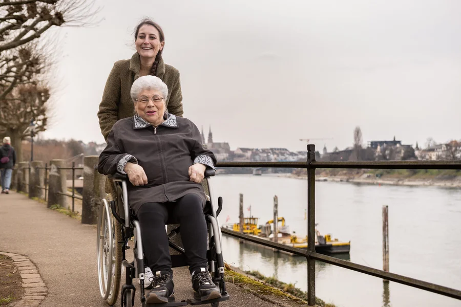 Fachperson und Klient:in bei einer gemeinsamen Aktivität im Wohnzimmer